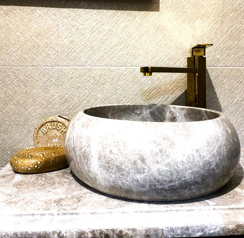 a large rock sink on a counter in a bathroom at Cottage Rest in kazbegi in Stepantsminda