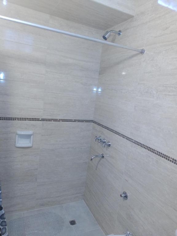 a bathroom with a large shower with a shower at Departamento sierras Balcarce in Balcarce