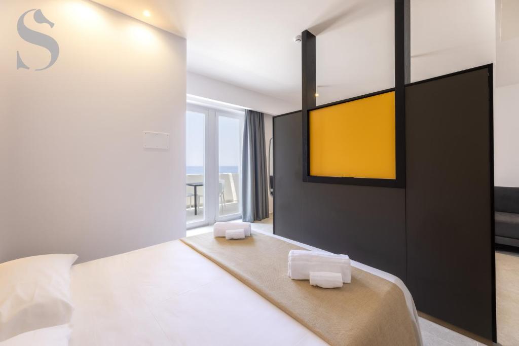 Postel nebo postele na pokoji v ubytování Sud Hotel Pulsano