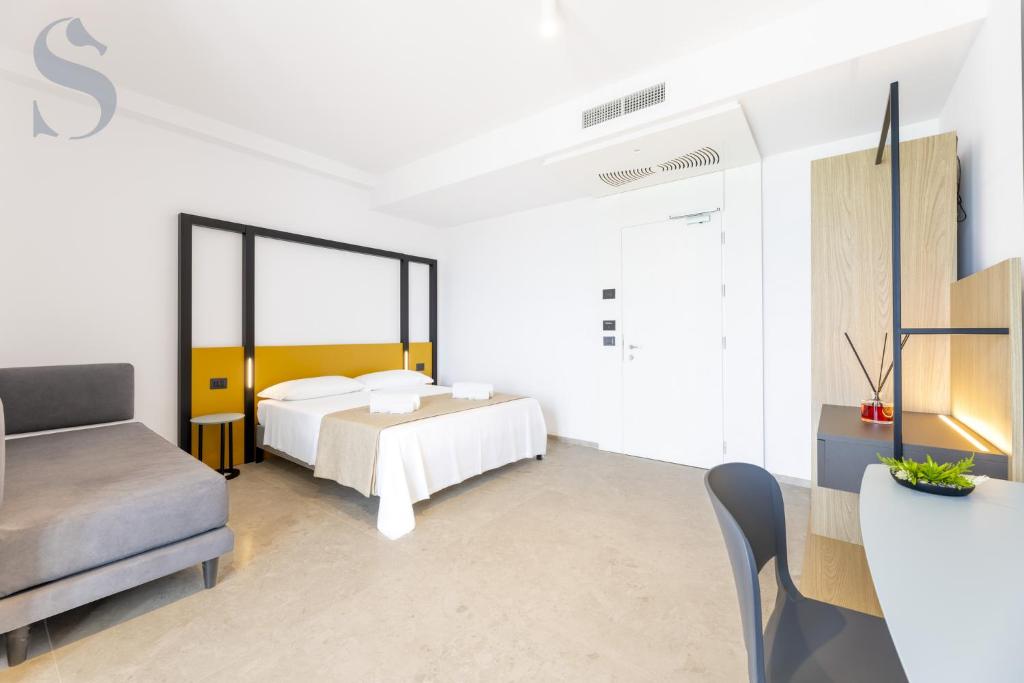 Postel nebo postele na pokoji v ubytování Sud Hotel Pulsano