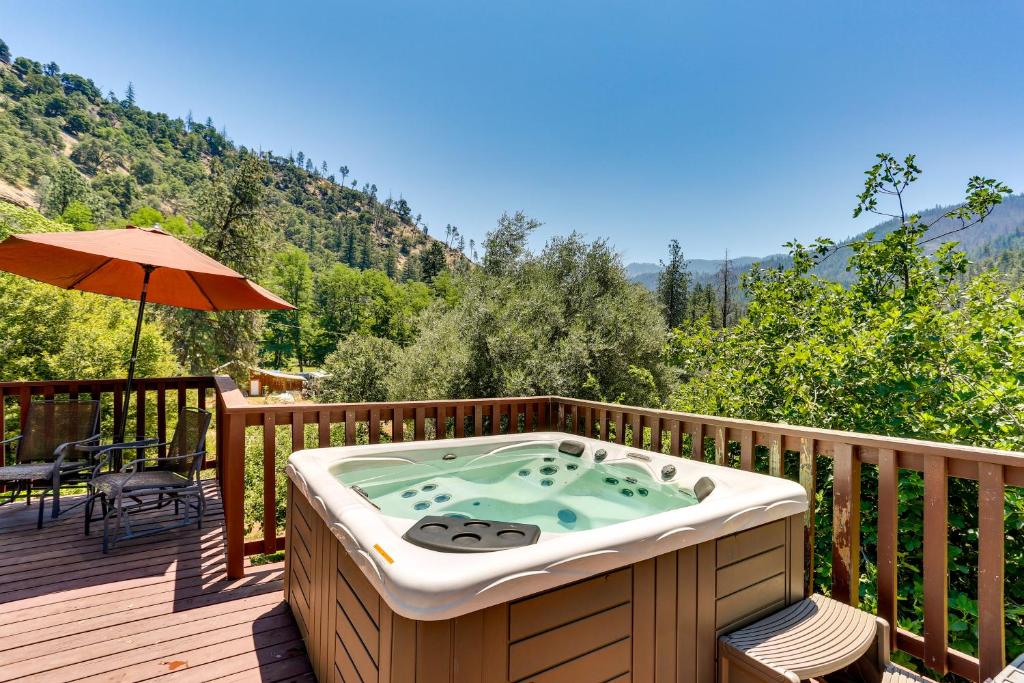 a hot tub on the deck of a house at Big Bar Home with Hot Tub and Fire Pit! in Big Bar