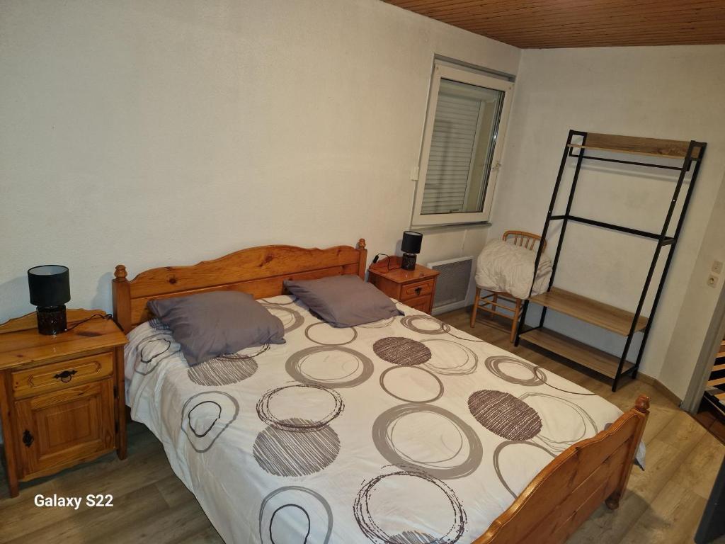 1 dormitorio con 1 cama grande y 1 silla en HAUT-DOUBS Logis, en Morteau