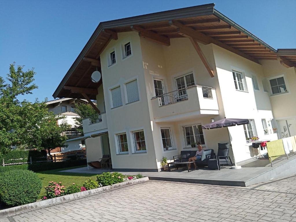 a person sitting in a chair in front of a building at Appartement Juffinger in Thiersee