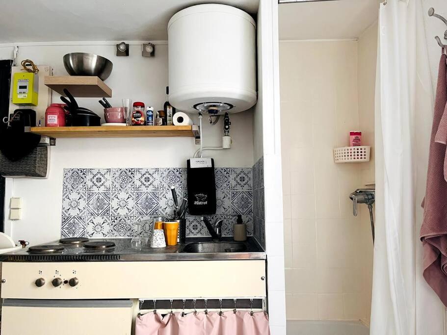a small kitchen with a sink and a stove at Cute Marais Private Studio for 2 in Paris