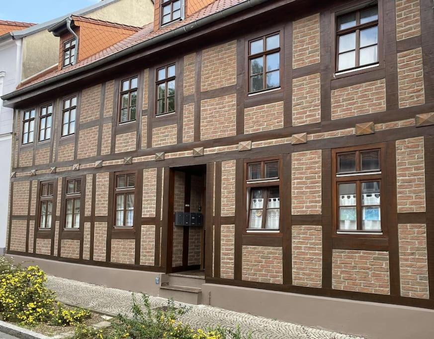 a brown brick building with windows on a street at AltstadtQuartier Burg in Burg bei Magdeburg