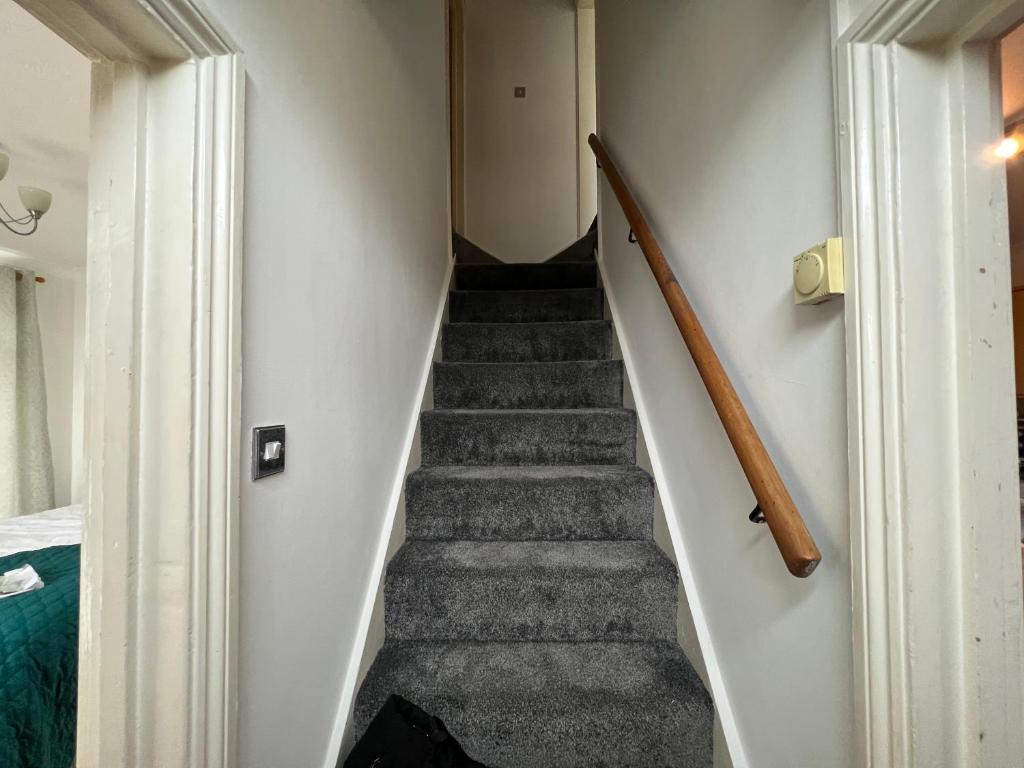 a staircase in a room with a stair case at Guesthouse Kettering City Centre in Kettering