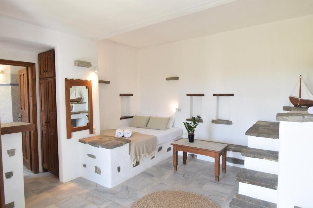 a bedroom with a bed and a table and a mirror at Sunset Pounda in Pounda