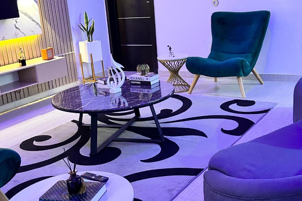 a living room with a table and two chairs at Luxury Shortlet Apartment LBS, AJAH in Lagos