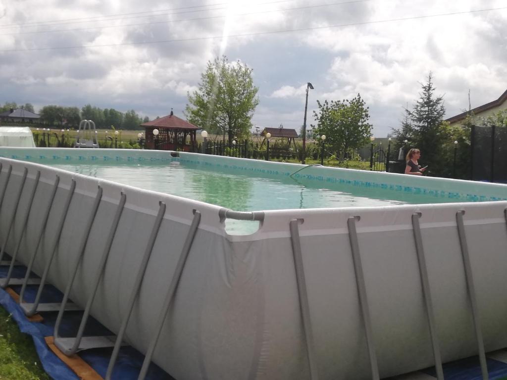 a swimming pool with a fence around it at Zacisze kurpiowskie u janusza in Zalas