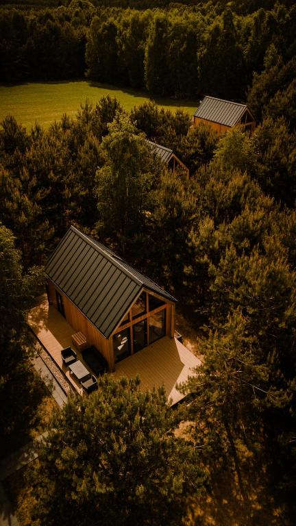 an overhead view of a house in the middle of trees at LASpot Szafarnia in Szafarnia