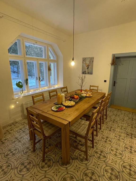 una sala da pranzo con tavolo e sedie in legno di Chalupa U Studánky a Holany