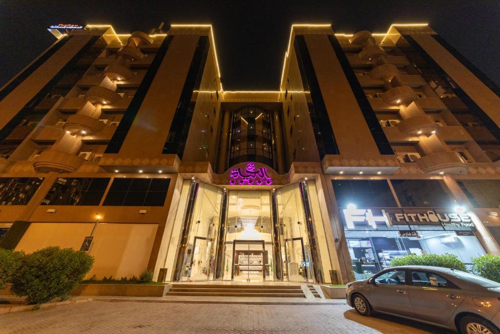 a car parked in front of a building at night at Burj Al Hayat Hotel Suites - Al Olaya in Riyadh