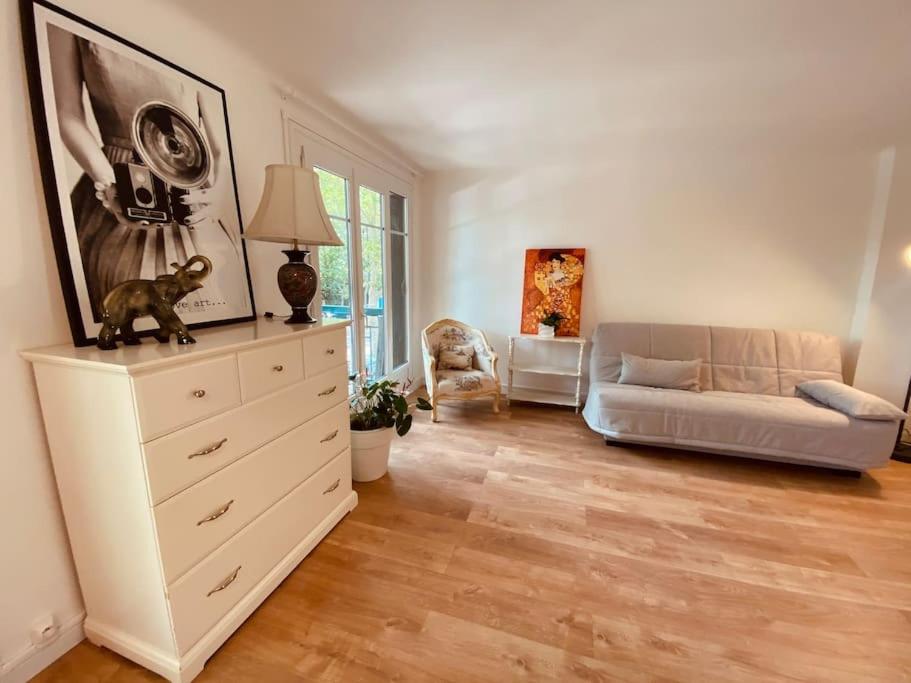 - un salon avec une commode et un canapé dans l'établissement Cosy T4 75m2 charmant près de La Défense Paris, à Rueil-Malmaison