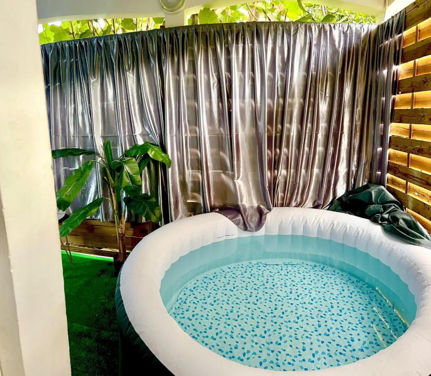 a bathroom with a bath tub in a room at La suite parentale in Basse-Terre
