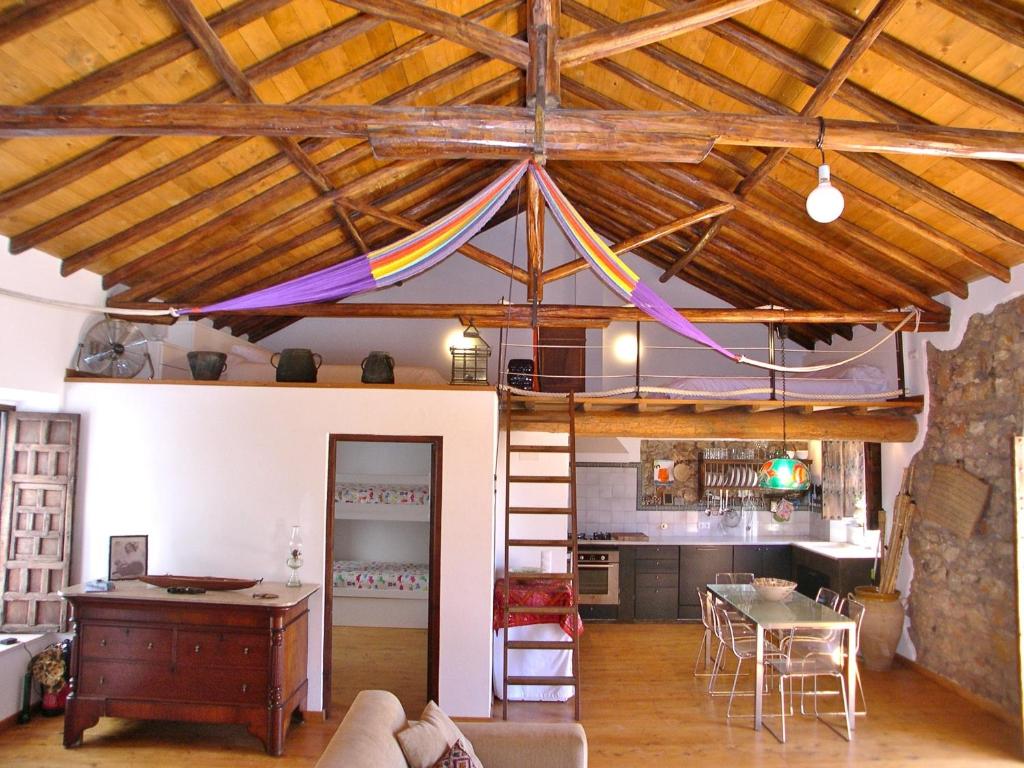 a living room with a loft with a bed in it at Casa Vila do Bispo in Vila do Bispo