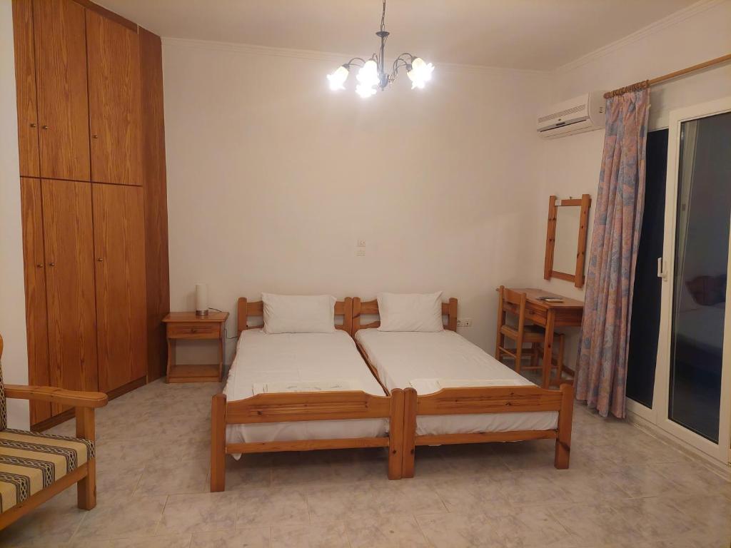 a bedroom with a bed and a dresser in it at Emilianos Studio in Chios