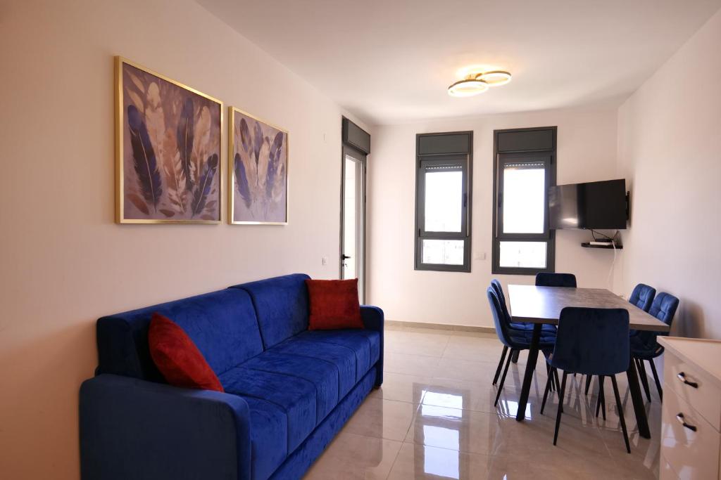 a living room with a blue couch and a table at 2BDR Suite#Next To The Market#Best Location in Jerusalem