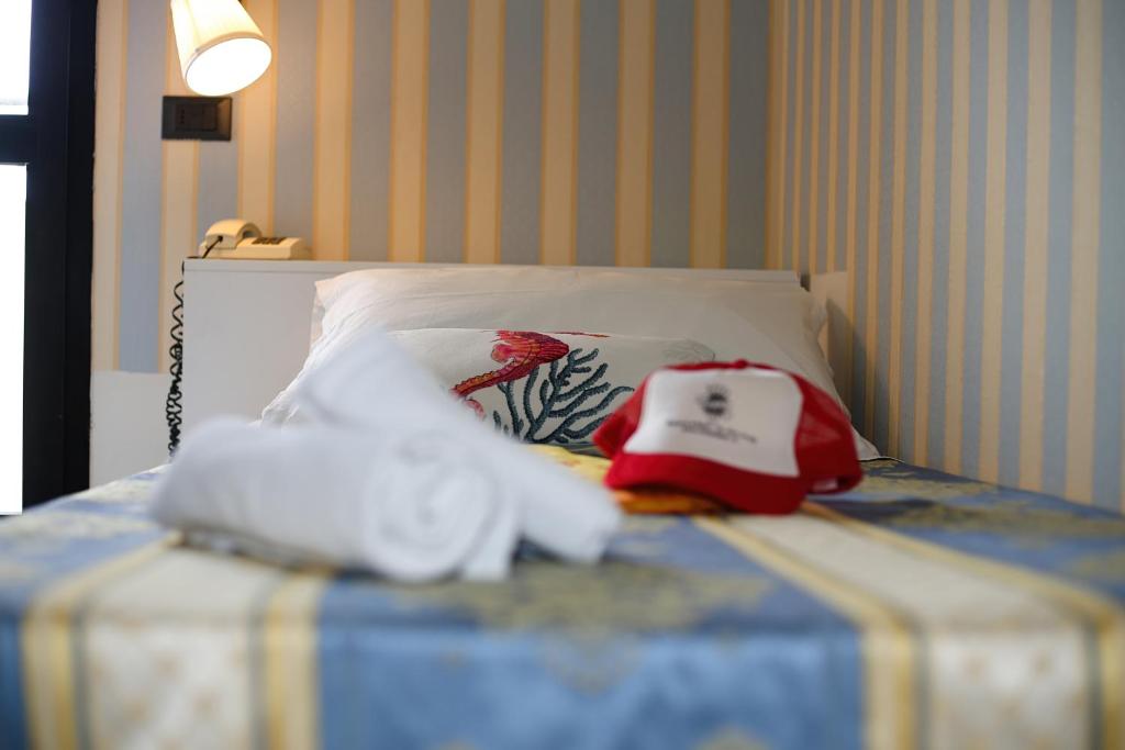 Postel nebo postele na pokoji v ubytování Hotel Dear Rimini