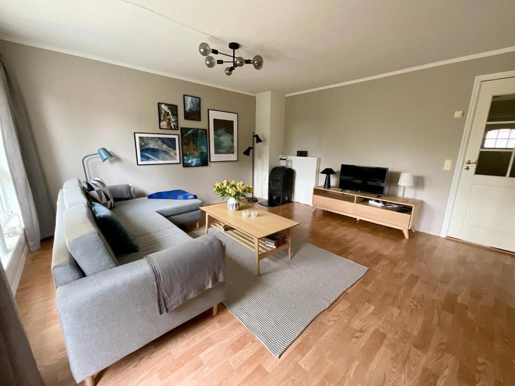a living room with a couch and a table at Leknes City Apartment in Leknes