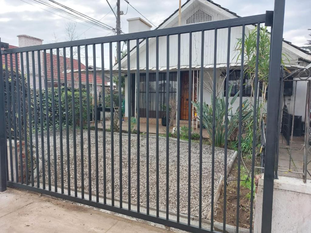 a metal fence in front of a house at Guest House GAAM Las Condes in Santiago