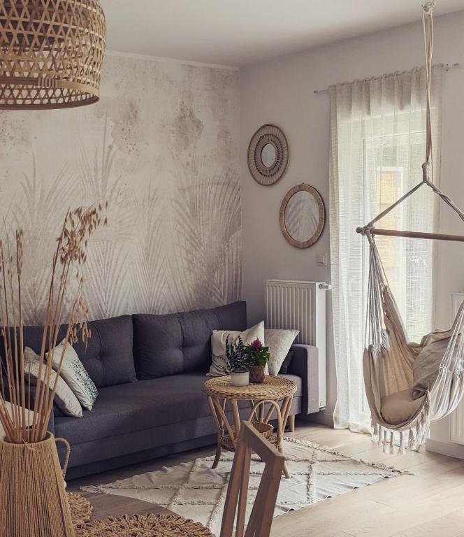 a living room with a blue couch and a table at Apartament Lis i Las in Sobótka