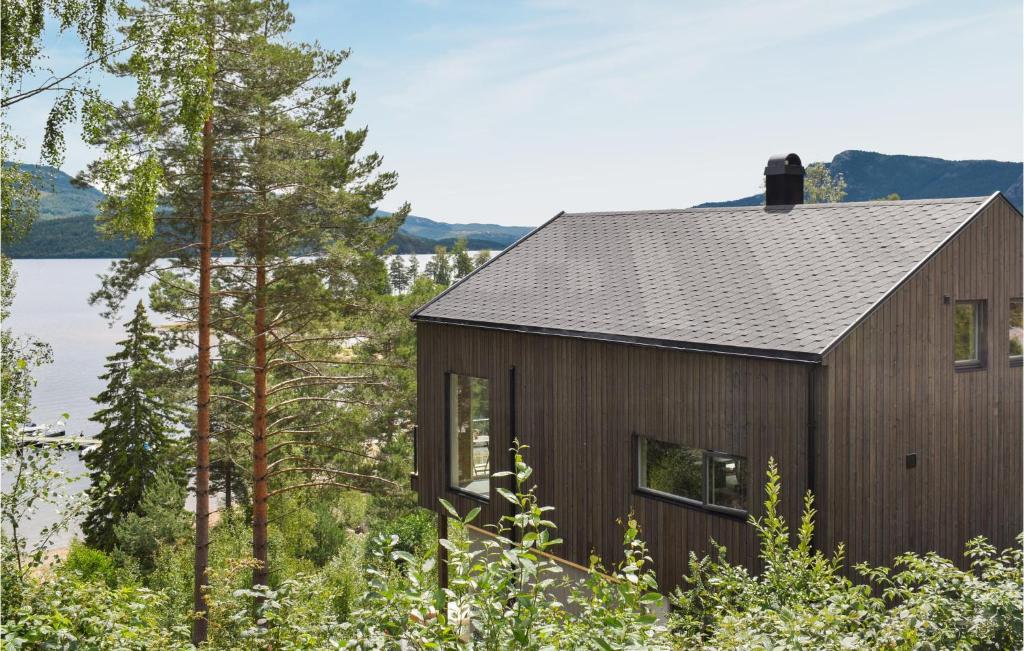 a house in the woods with a view of a lake at Nice Home In Treungen With Kitchen in Treungen