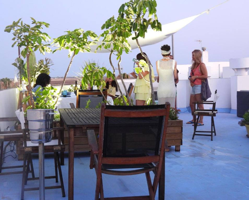 a group of women standing on a balcony with potted plants at ABA DALÍ in Conil de la Frontera