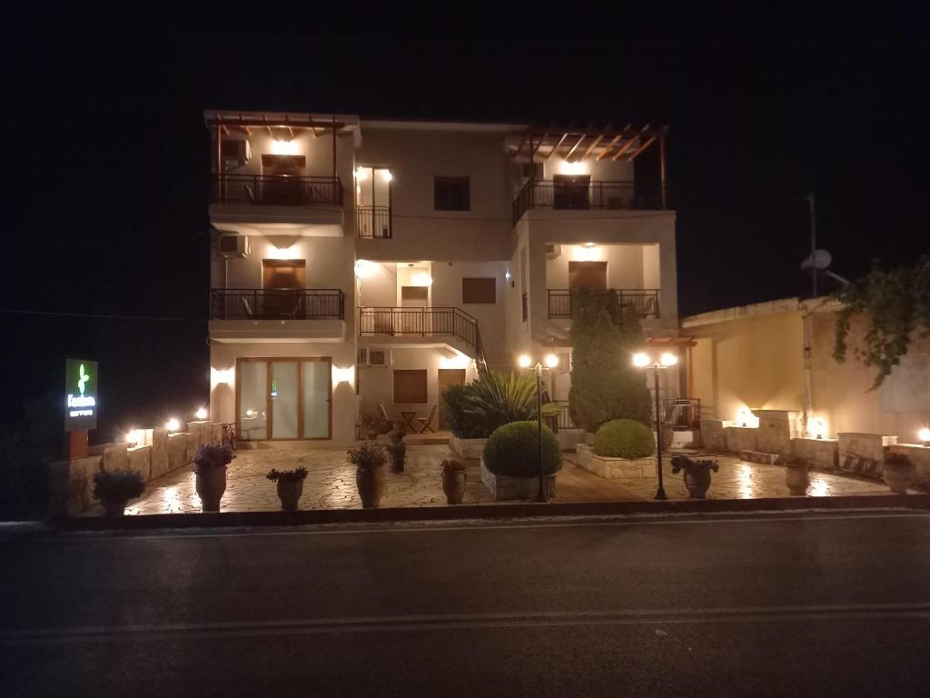 a building with lights in front of it at night at Kandania Apartments in Kántanos