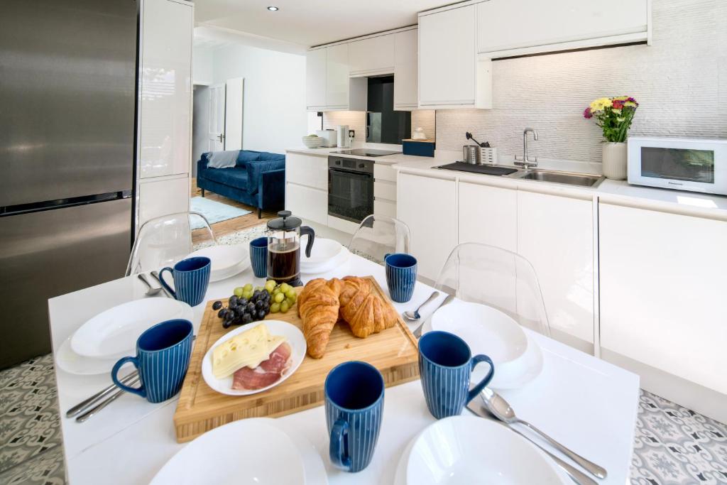a kitchen with a table with a plate of food on it at Marina Bridge House Central Cowes in Cowes