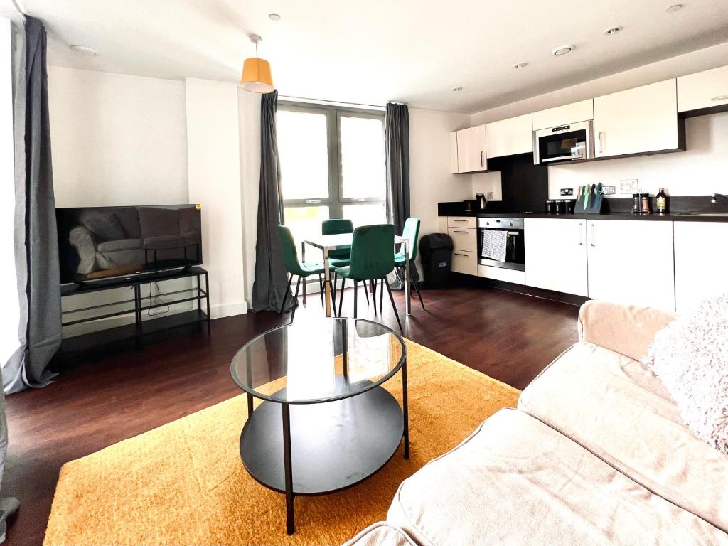 a living room with a couch and a table at Venice Court London 2Bedroom Apartment in London