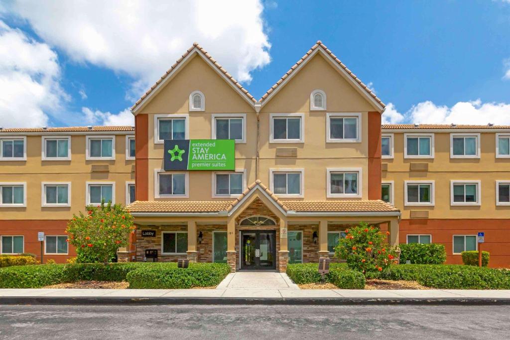 a building with a sign on the front of it at Extended Stay America Premier Suites - Miami - Airport - Miami Springs in Miami