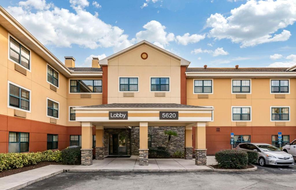 a building with a car parked in a parking lot at Extended Stay America Suites - Orlando - Orlando Theme Parks - Major Blvd in Orlando