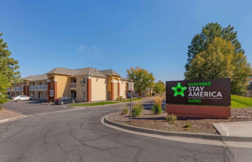 a sign for a stay america sign in front of a building at Extended Stay America Select Suites - Denver - Aurora South in Aurora