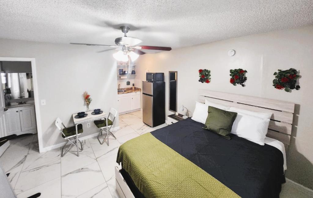 1 dormitorio con cama, escritorio y nevera en Adorable Mini Suite in Tampa, en Tampa