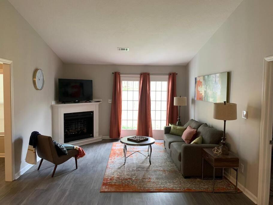 a living room with a couch and a fireplace at Comfy, Stylish Townhome Near I-20! in Augusta