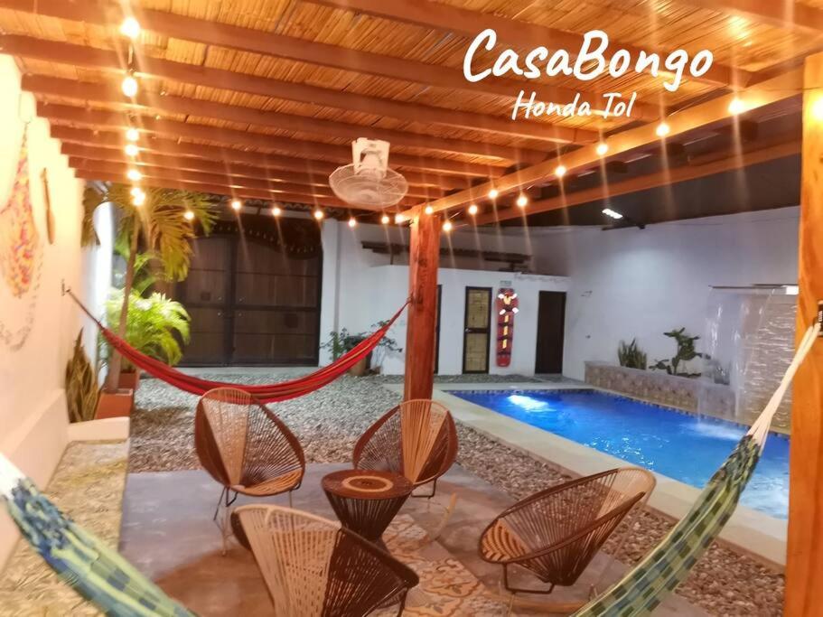 a room with a hammock and a swimming pool at CasaBongo, alojamiento vacacional con piscina in Honda