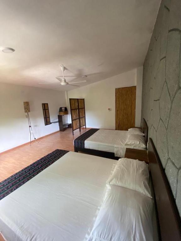 Postel nebo postele na pokoji v ubytování Tonantzincalli SPA Prehispanico
