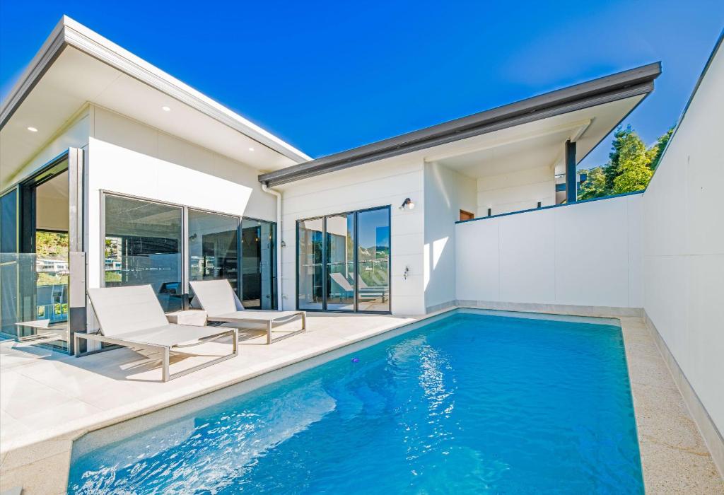 a swimming pool in the backyard of a house at 3 Bedroom Holiday Home Valley Views in Airlie Beach in Airlie Beach