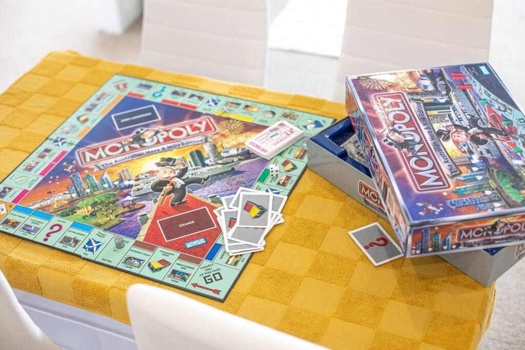 a table with two monopoly board games on it at Entire Apartment in Ryde in Sydney