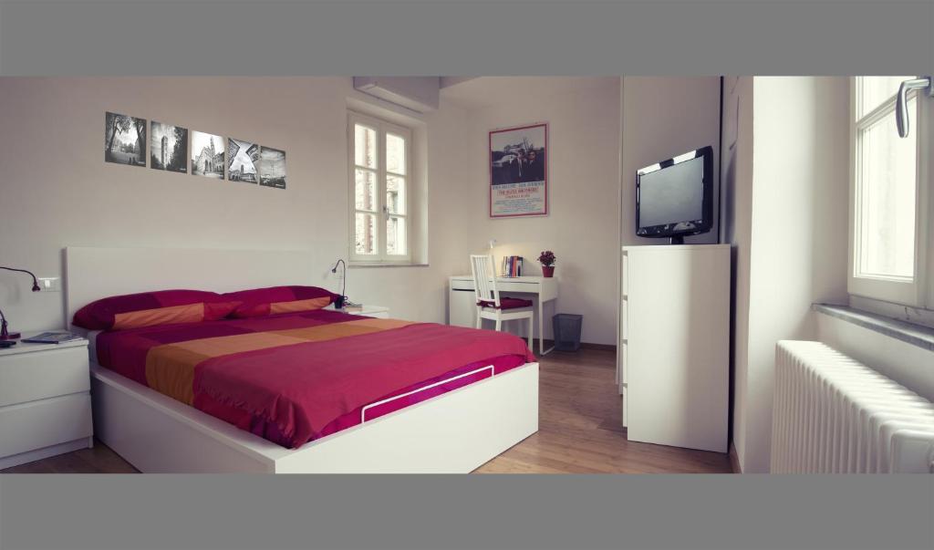 a bedroom with a bed and a flat screen tv at John B .&B. in Lucca