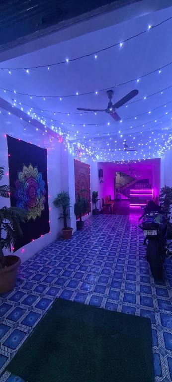 a room with purple lights and a room with plants at Hotel Citi Heart in Port Blair