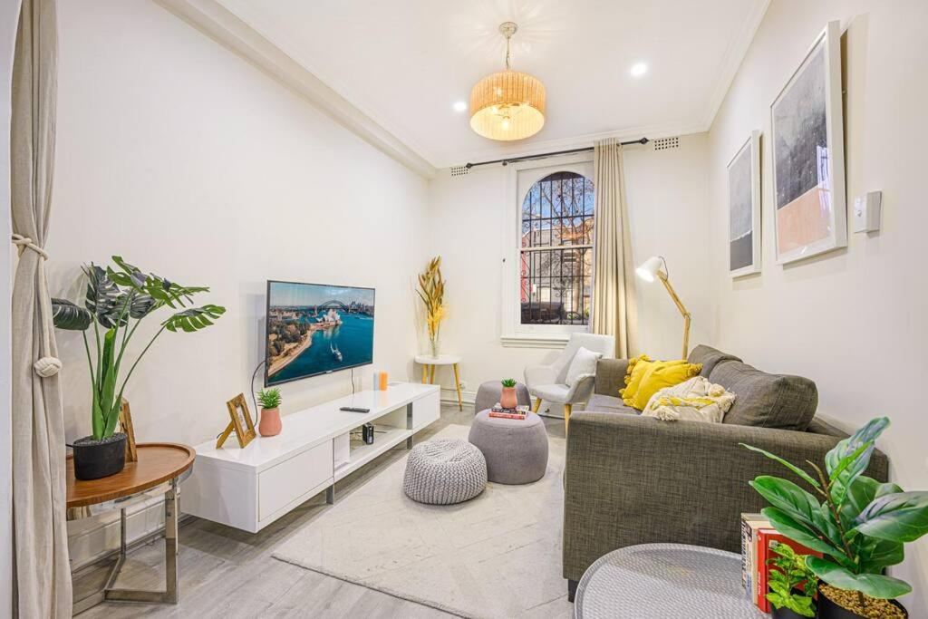 a living room with a couch and a table at Cozy 3 bedroom terrace in CBD in Sydney