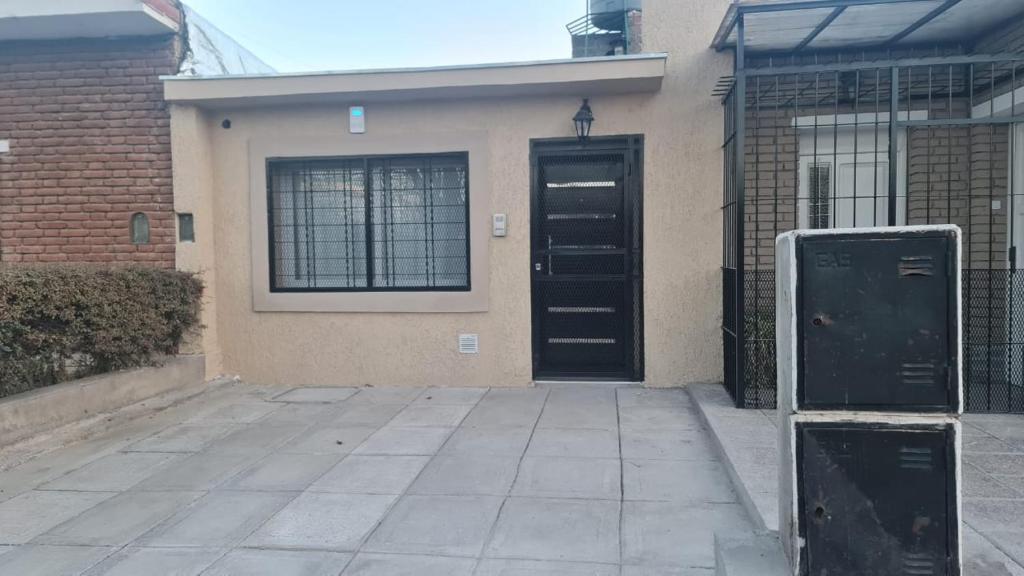 a house with a black door in front of it at Complejo Consolata Mendoza in Guaymallen