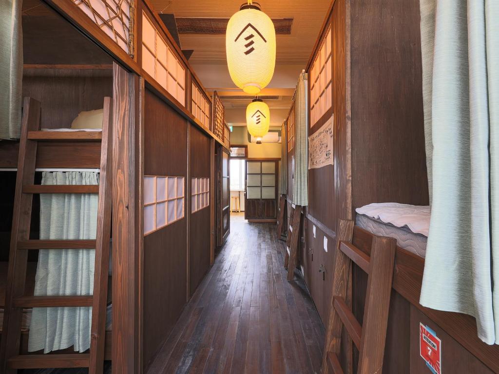 a hallway of a room with several bunk beds at Yamagata Guesthouse山形ゲストハウス in Murayama