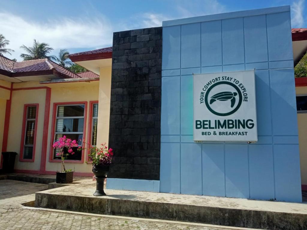 a building with a sign for a buildingling job and supermarket at Belimbing Bed & Breakfast in Lampuyang