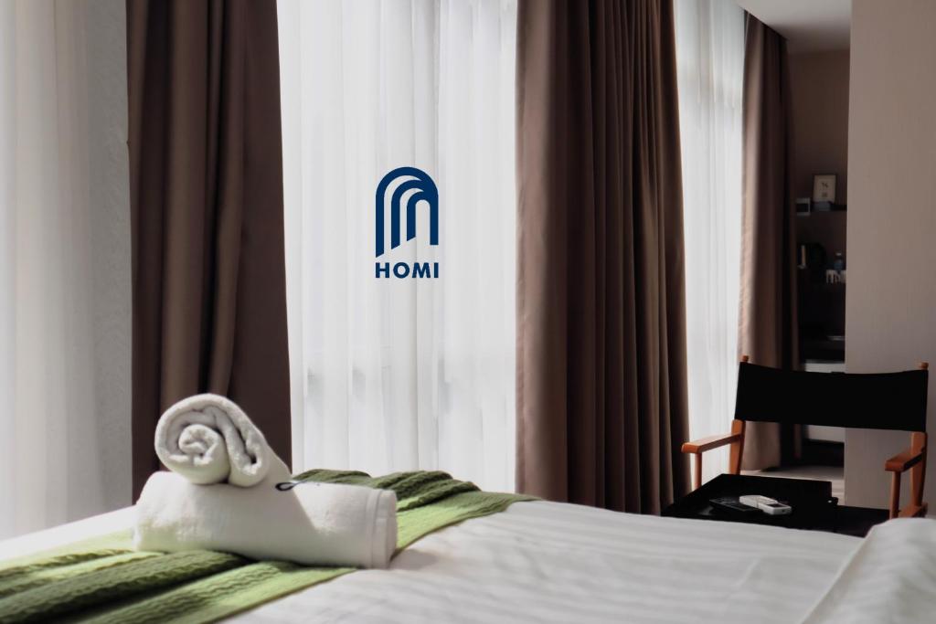 Postel nebo postele na pokoji v ubytování Homi Oasis at KK Times Square 和逸绿洲