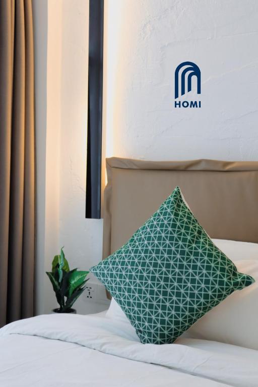 Postel nebo postele na pokoji v ubytování Homi Oasis at KK Times Square 和逸绿洲