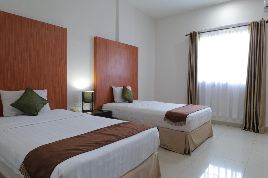 Postel nebo postele na pokoji v ubytování Saka Hotel Medan