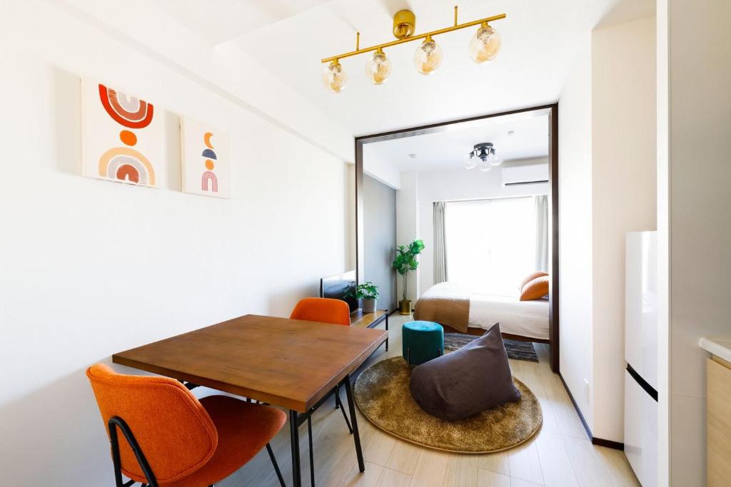 a small apartment with a dining room table and a bedroom at MAT Oshiage in Tokyo