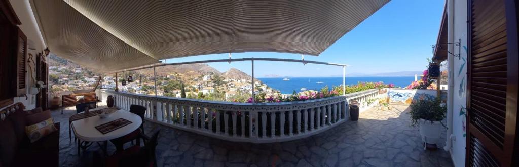 a balcony of a building with a view of the ocean at Panoramic Views Home in Hydra, Greece in Hydra